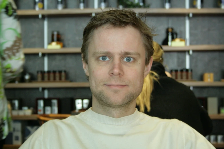 a man posing for the camera, with his face looking forward