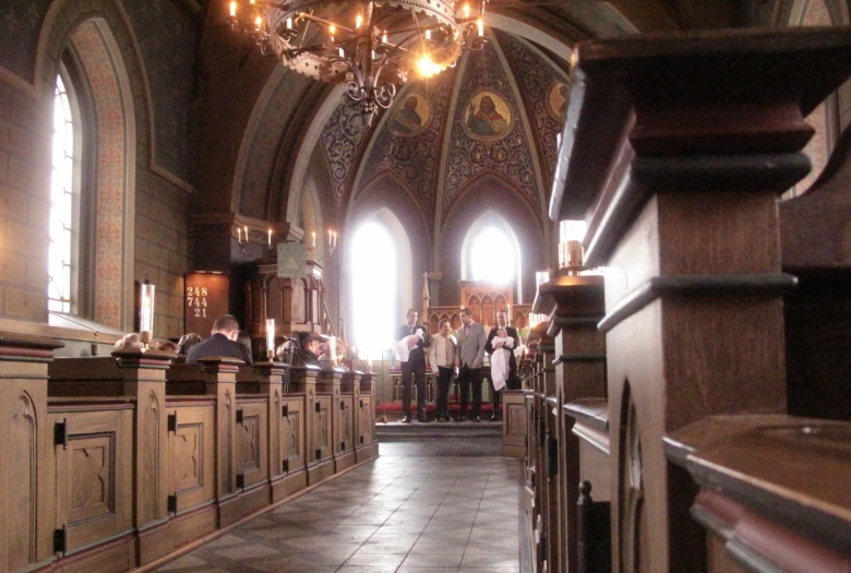 people standing inside a large church in front of tall windows