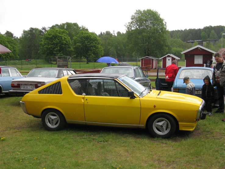 the yellow car is parked at the event