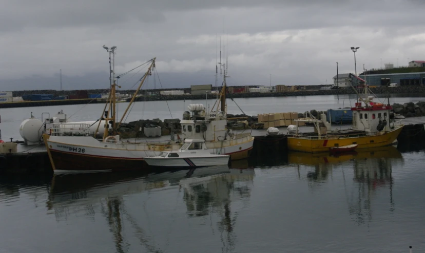 three ships docked on the docks next to each other