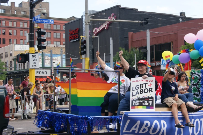 a group of people standing on the back of a truck