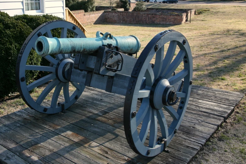 the old gun is sitting on the deck of a house