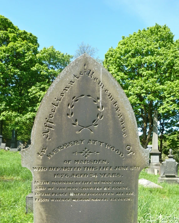 a memorial stone with a circular writing marks