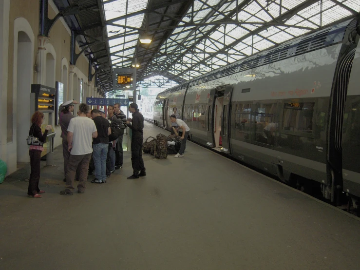 people are standing in line at the train station