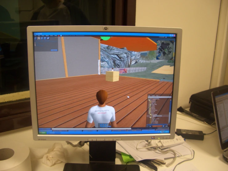 a computer monitor with an animated guy sitting in front of it