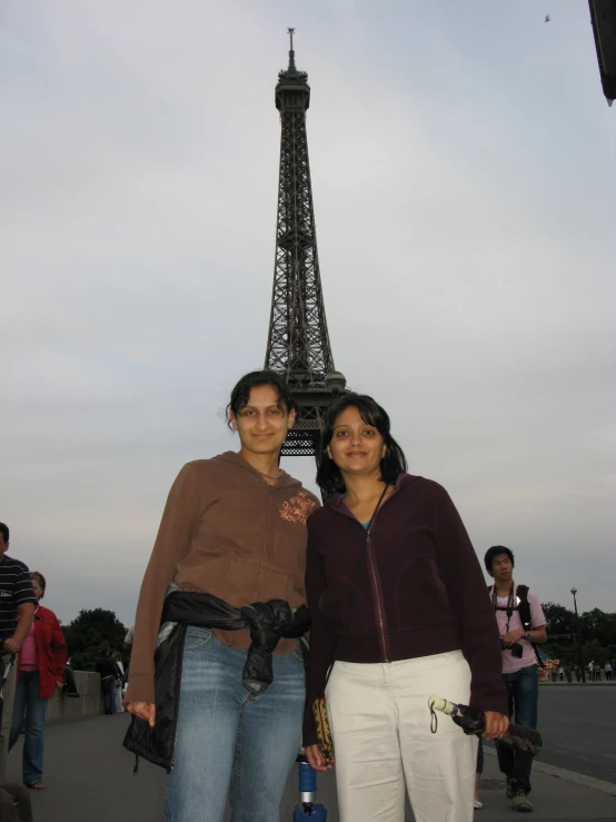 two women in front of a tour eiffel tower