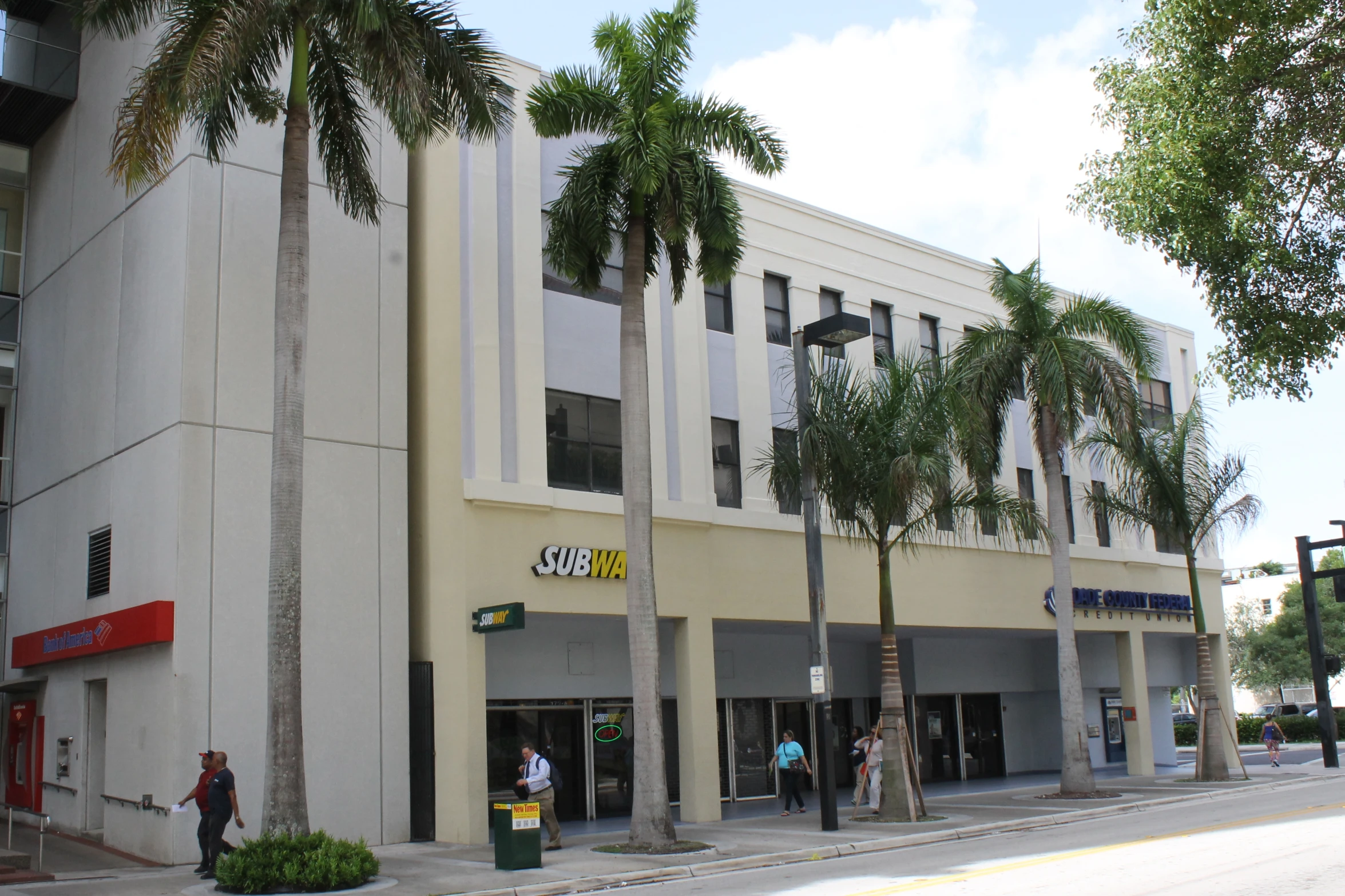 the shopfront and side of the building is a yellow color