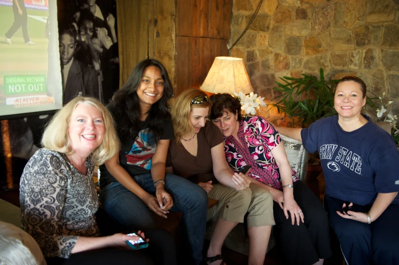 a group of women posing for the camera in a room