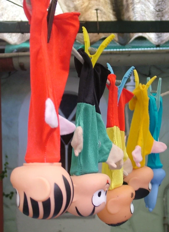 an assortment of windchikes on the ceiling next to a cat