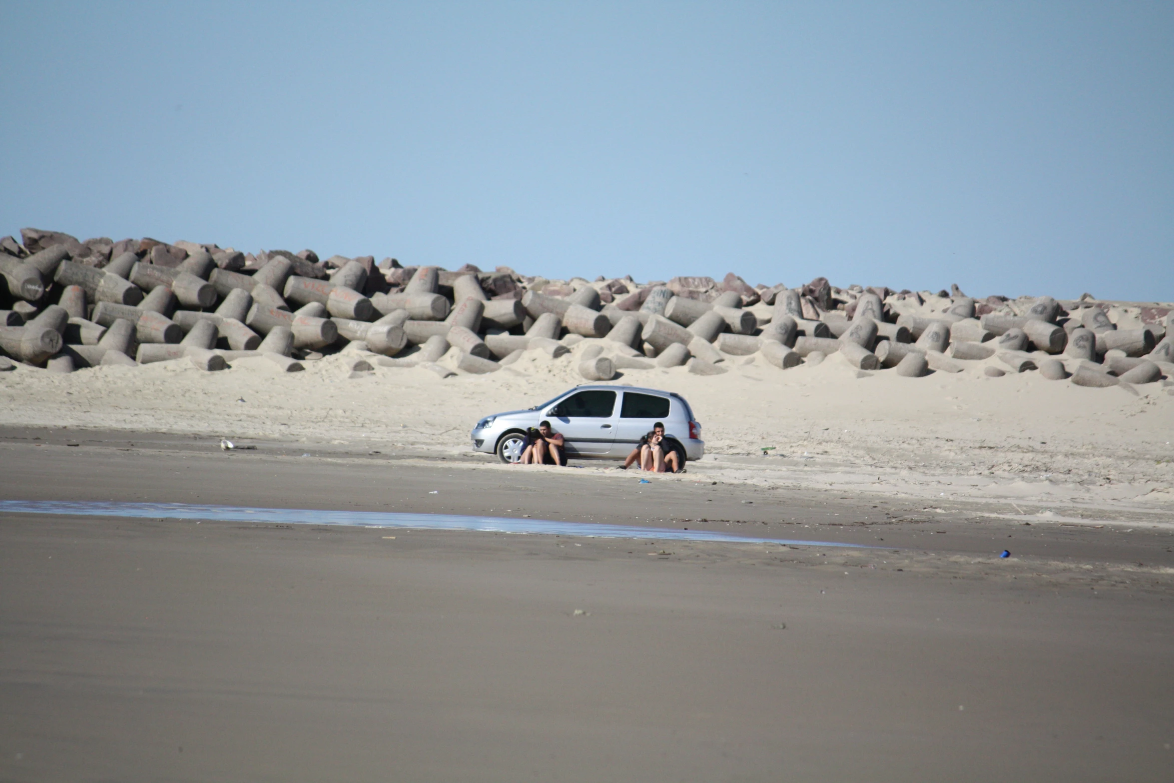 an automobile with four people in the desert