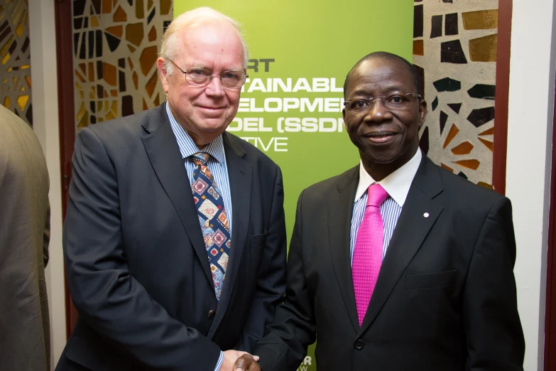 two men in suits standing next to each other