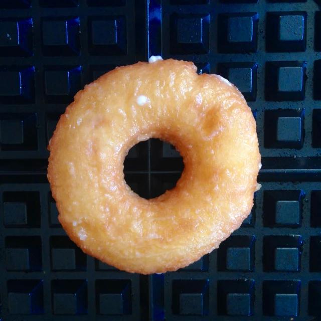 a close up of a donut on a baking pan