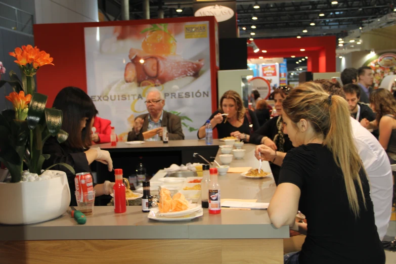 a group of people sitting at a table eating