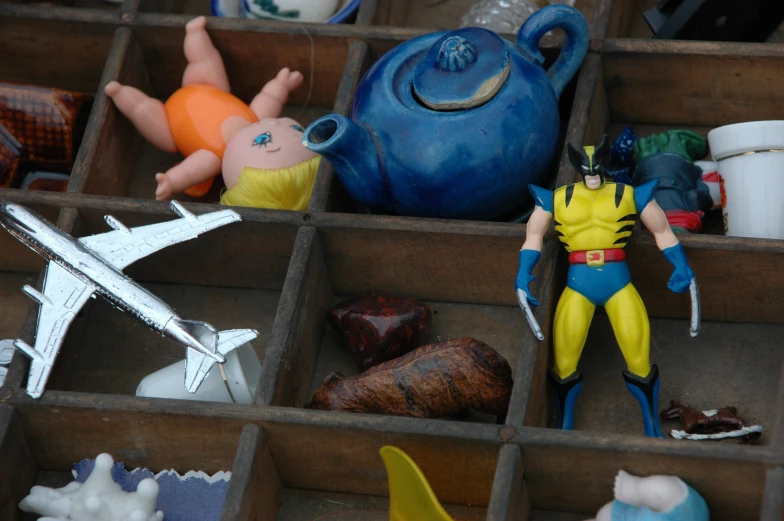 a toy figure in a tray next to other plastic figures