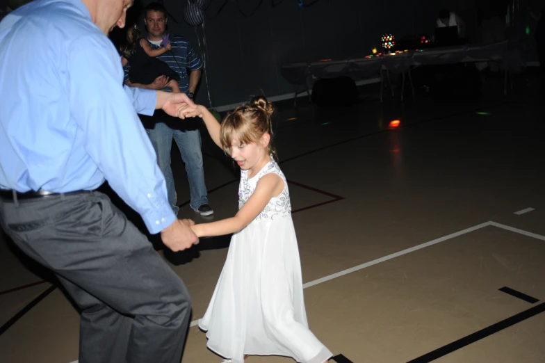 a girl in a dress holding her arm