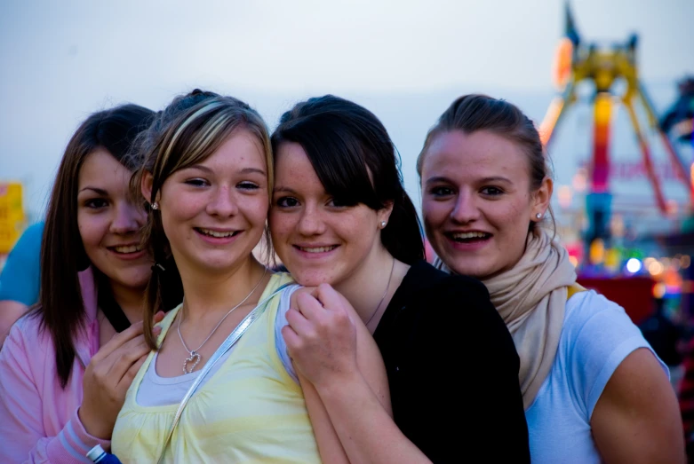 a group of girls standing together in front of an amut park