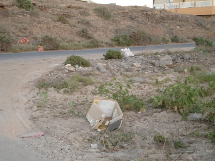 there are many trash cans on the side of a road