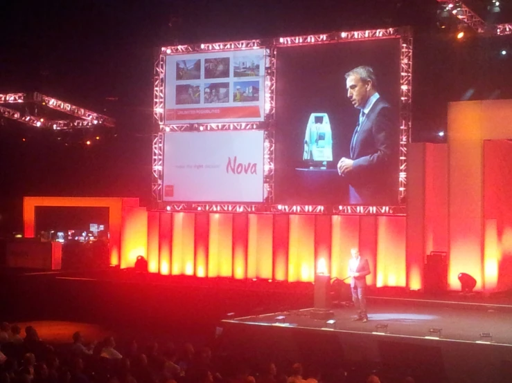 there is a man on a stage giving a speech