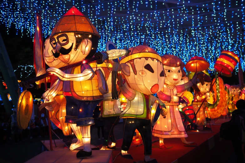 a group of people stand behind a large set of lighted decorations