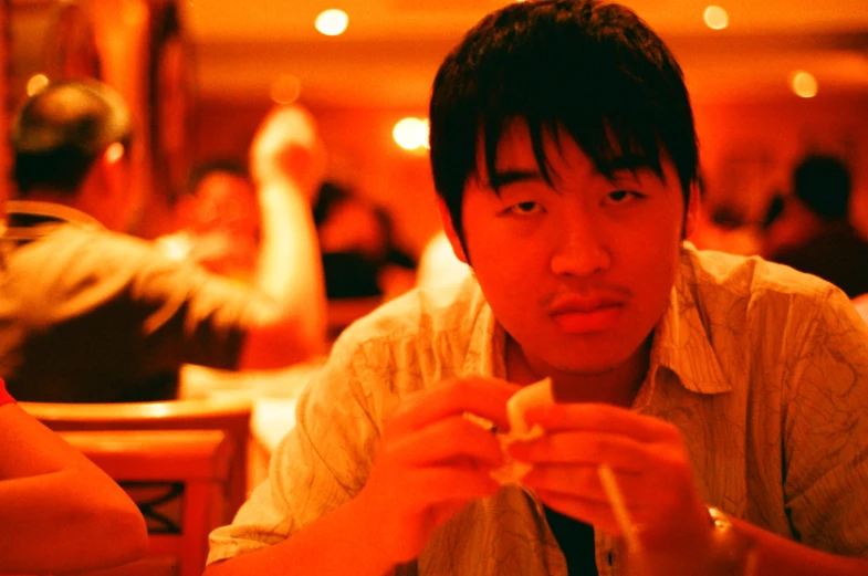 man looking at camera while eating from a plate