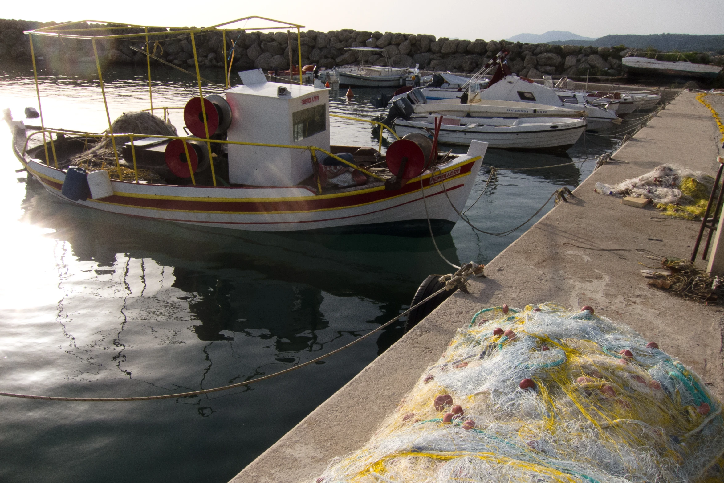 a group of boats docked at a small harbor