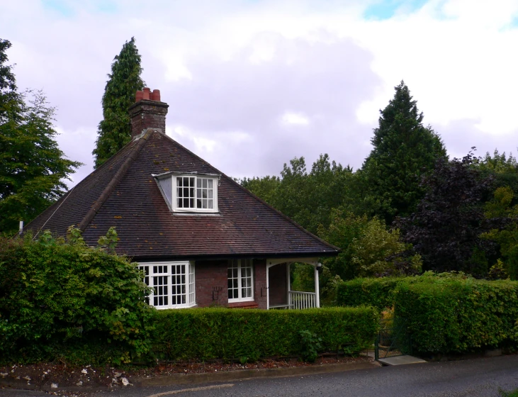 a house on the corner of a driveway