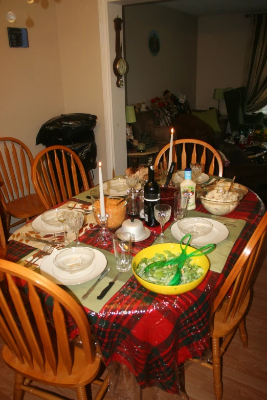 a large red table with dishes and glasses on it