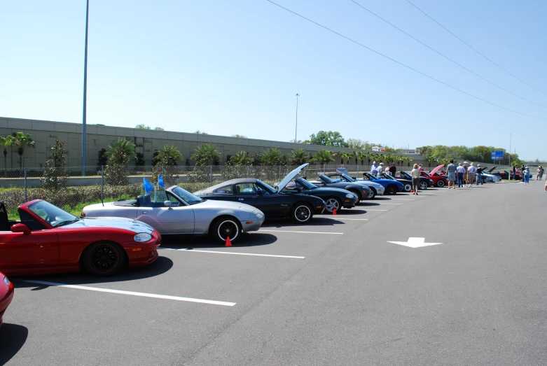 row of sports cars waiting in parking lot on clear day
