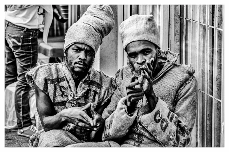 a black and white po of two men smoking cigarette