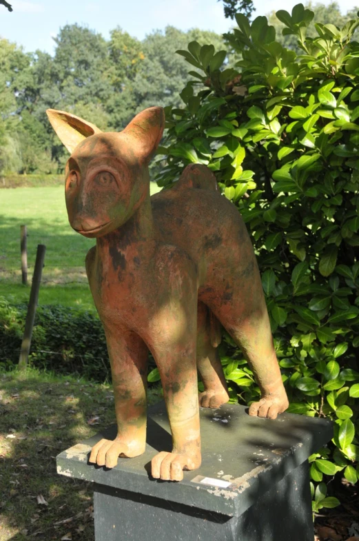 an animal statue sitting in the middle of the park