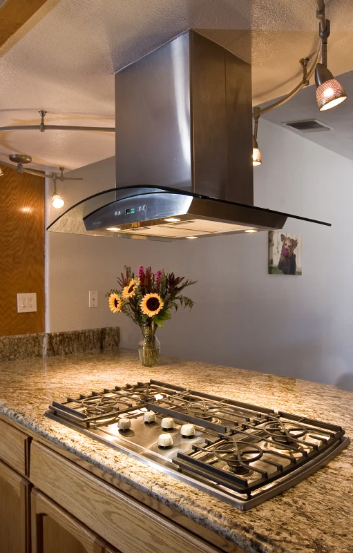 a glass stove top oven and stove hood above it