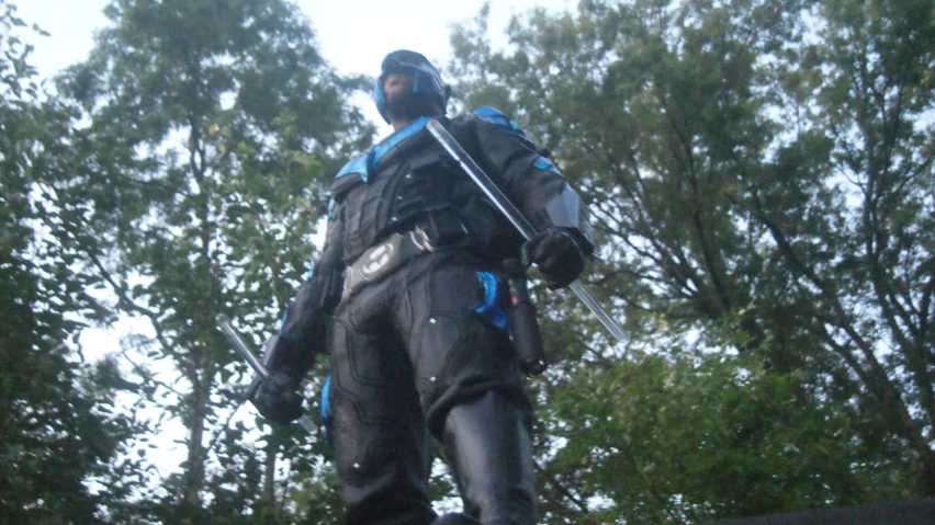 a person in full gear standing with a stick