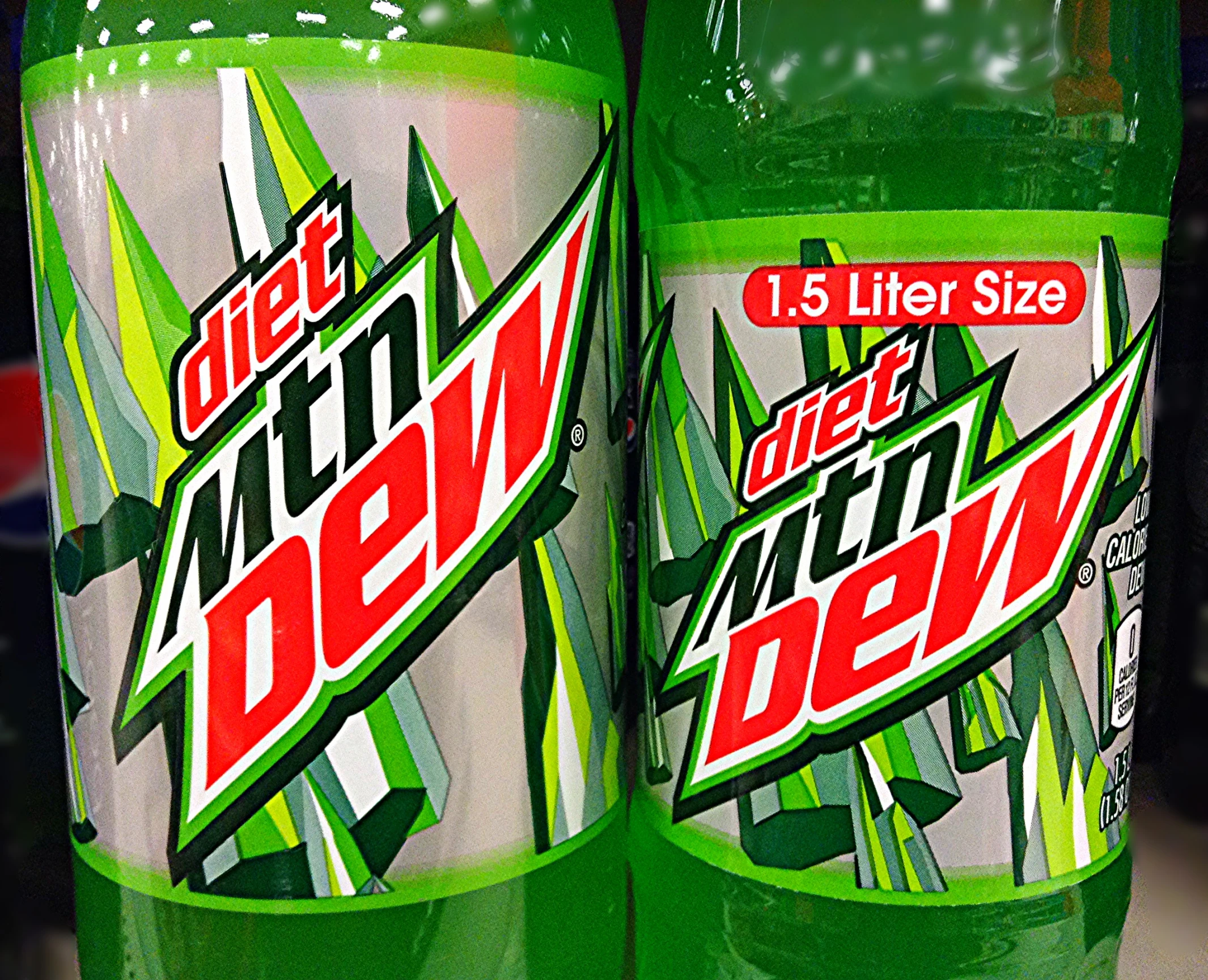 two soda bottles of mountain dew are displayed