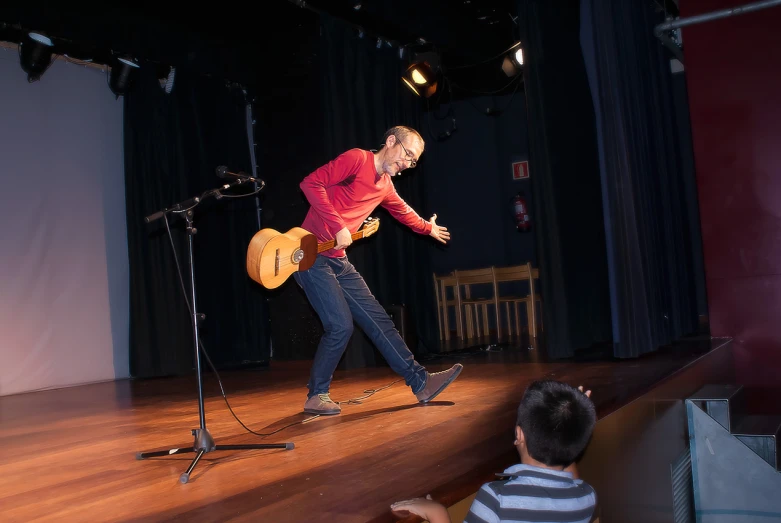 a man plays a guitar with a little boy