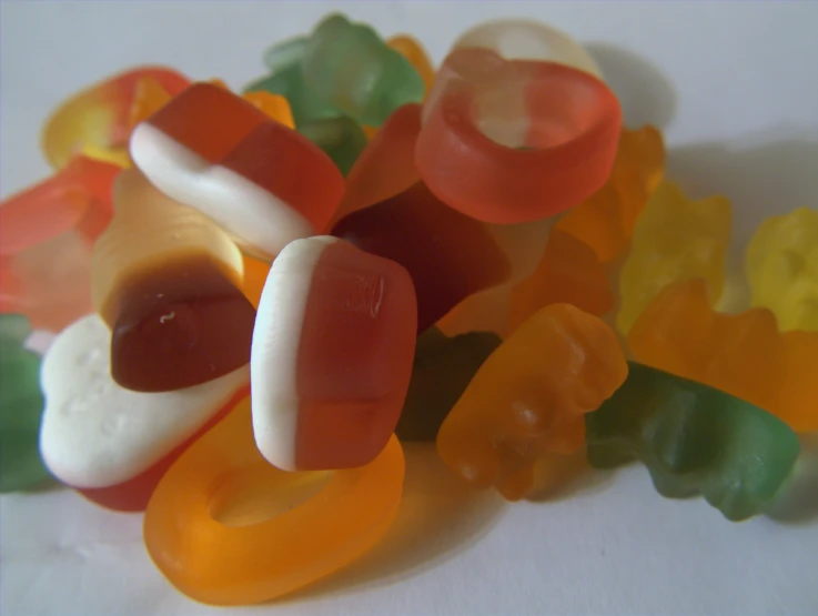 an assortment of gummy bears sitting in a pile