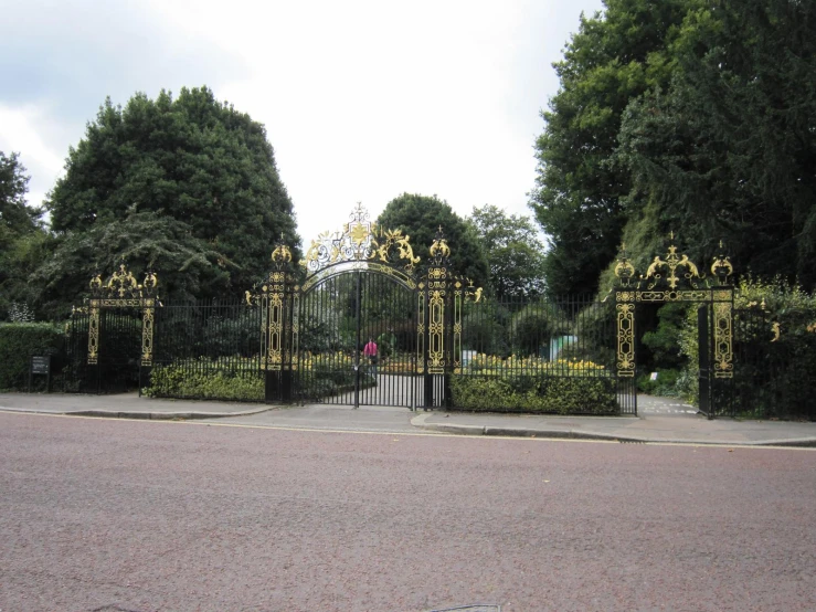 a couple of people walking by a gate