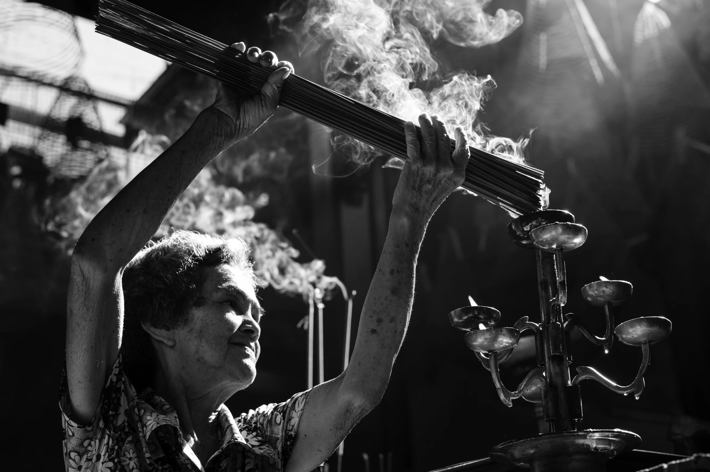 a man with smoke coming out of his mouth and arms holds onto a bar