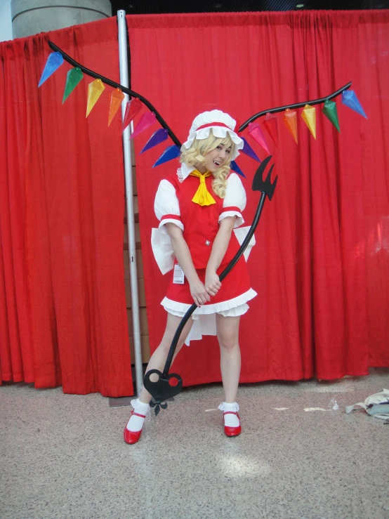 a child standing by a pole while dressed in a costume