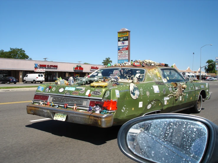 the back of a truck covered in items and pictures