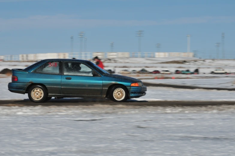 a car drives on a snowy road