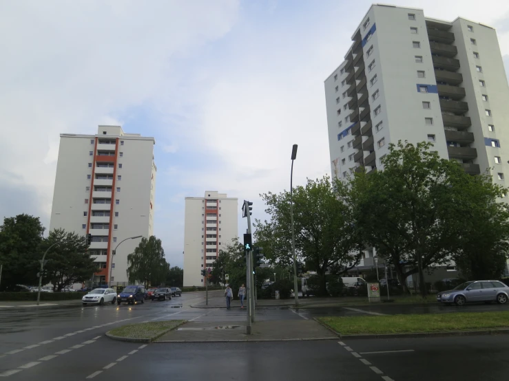 street and sidewalk intersection with residential buildings in the distance