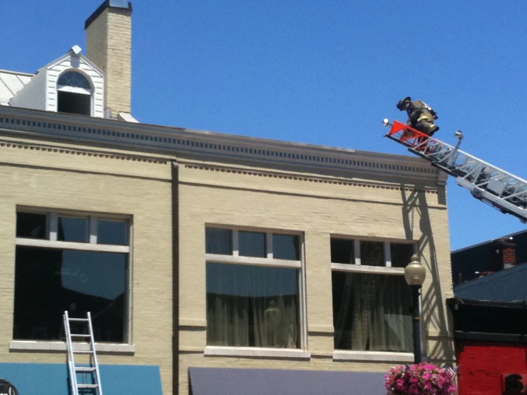 a man is on the ladder working on a building