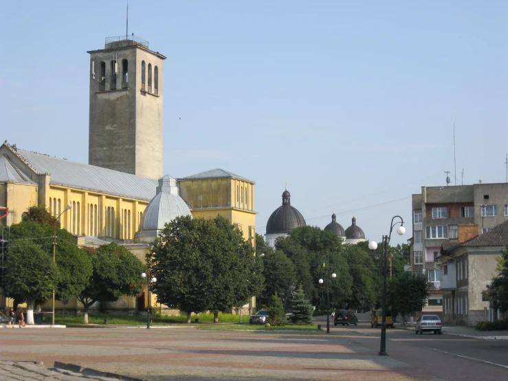 a clock tower stands above buildings in the distance