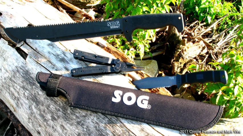 three knifes that say sog in white writing on a wooden surface
