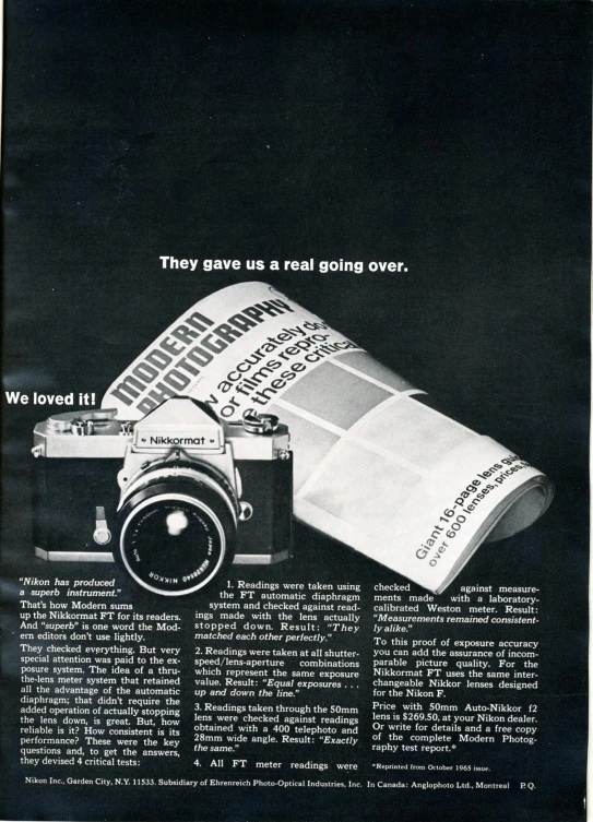 a camera sitting next to a newspaper on a table