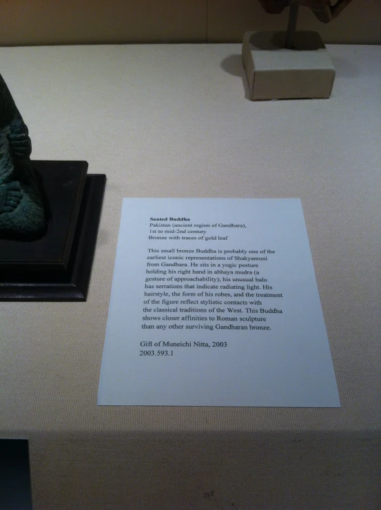 an old typewriter sitting on a table next to a statue