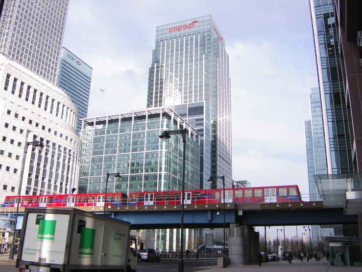 people on a bridge in front of tall buildings