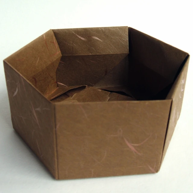 there is a small square paper box with lid