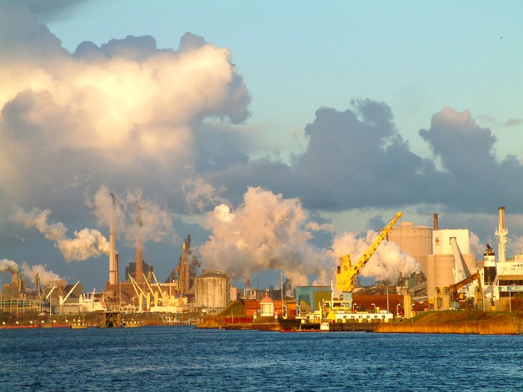 a city skyline with factory buildings and industrial smokestacks