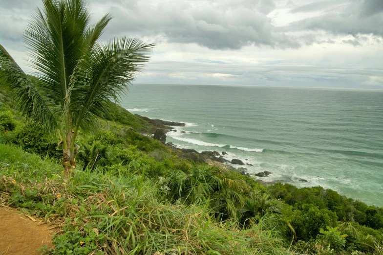 the ocean and the sky as seen from a cliff